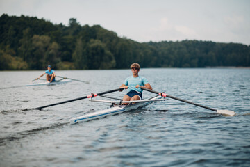 Sportsman oarsman single scull man rower rowing on boat oars. - 526821805