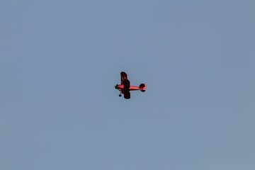 Vintage biplane flying in the cloudless sky