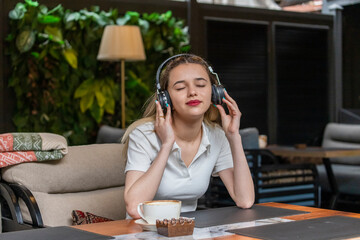 Young lady close to her eyes and listening music