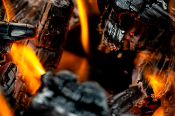 Fire burning inside a pit of charcoal