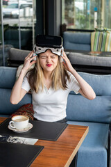 Cute blonde wrinkled her lips and wearing VR set