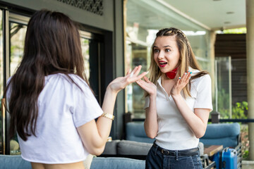 Young lady with her friend talking at the street