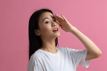 Portrait of asian woman on pink background.