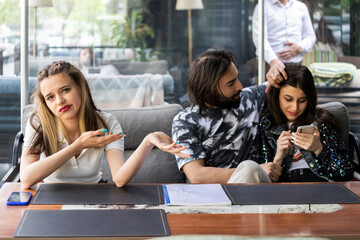 young couple sitting with their friend at the restauarant