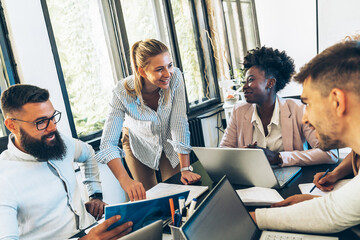 Day in the business office. A group of young businesspeople discussing ideas at the office for a new startup project.	
