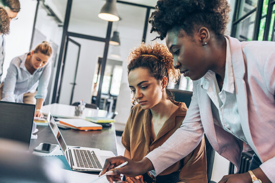 Senior finance manager helps her new employee to find a solution for her task.	
 - Powered by Adobe