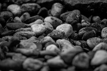 small rocks laying on the ground in black and white