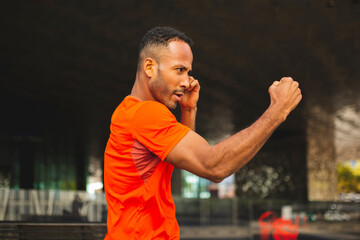 Athletic man punching air with clenched fist