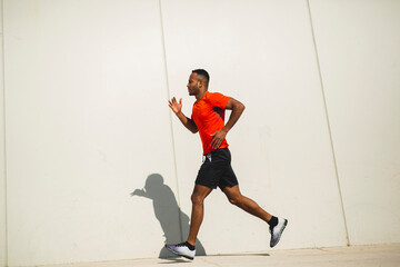 Full length side portrait african american man running