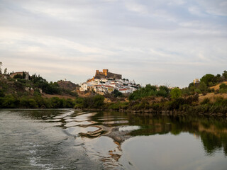 Fototapeta na wymiar Mertola village topped by the castle seen from Guadiana River