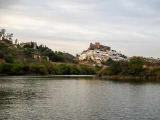 Fototapeta na wymiar Mertola village topped by the castle seen from Guadiana River