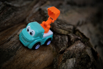 Fototapeta premium Children's toy car on stones and sand