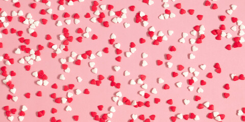 Valentine's Day pattern background. Composition with candy hearts. Symbol heart of sweets on pastel pink background. Flat lay, top view