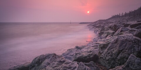 Beautiful coast of Reculver in England, during a pinky sunset