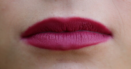 Lips macro closeup detail. Woman wearing red lipstick close-up face