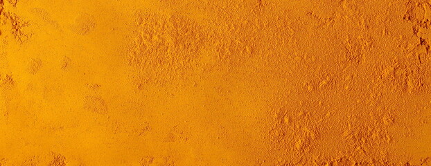 Turmeric (Curcuma) powder pile background and texture, top view