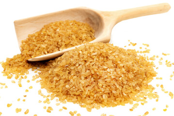 Bulgur wheat in a wooden spoon on a white background. Bulgur isolate