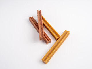 Close up dog tooth stick to reduce tartar buildup isolated on white.