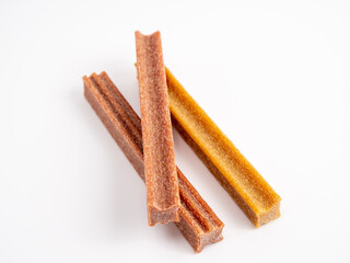 Close up dog tooth stick to reduce tartar buildup isolated on white.