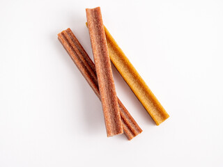 Close up dog tooth stick to reduce tartar buildup isolated on white.