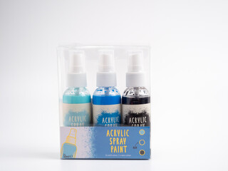 Vials of acrylic spray paint on a white background. Close-up.