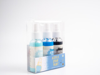 Vials of acrylic spray paint on a white background. Close-up.
