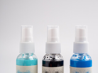 Vials of acrylic spray paint on a white background. Close-up.