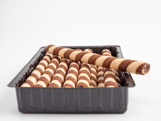 Chocolate wafer sticks or rolls, on a white background.