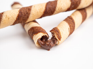 Chocolate wafer sticks or rolls, on a white background.