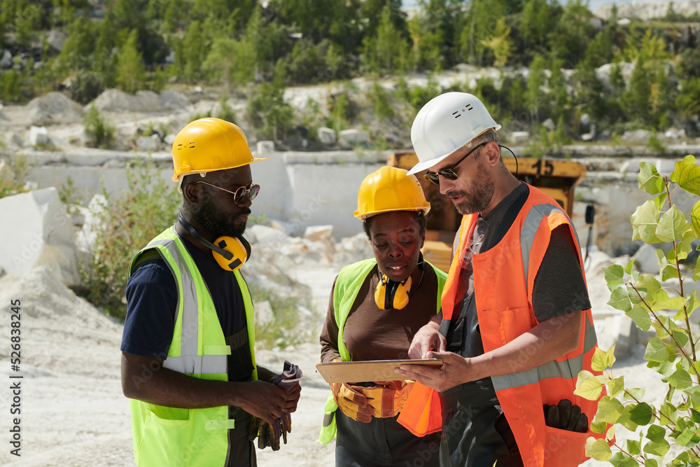 Aufkleber mature man in workwear pointing at tablet screen during presentation of new working project to his c