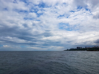 Seascape Sea with calm water and white clouds
