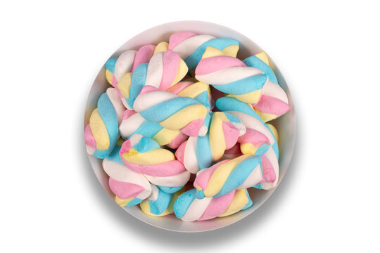Bowl with colorful candies on a white background. Top view.