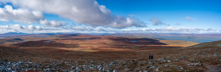 Vivid Autumn coloured Panorama Landscape in Remote wilderness of arctic Pieljekaise National Park South of Jakkvik, Sweden on a sunny autumn day with yellow and orange colors in nature.