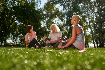 Woman looking at cheerful senior couple in park