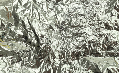 Silver glitter foil crumpled paper. Abstract glow shine texture copy space background.