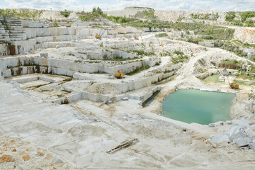 Above view of part of vast territory of modern quarry belonging to industrial production factory...