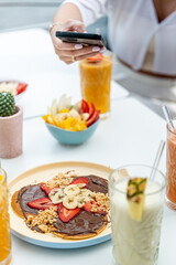 Healthy breakfast with delicious pancakes with sweet strawberries, banana and chocolate 