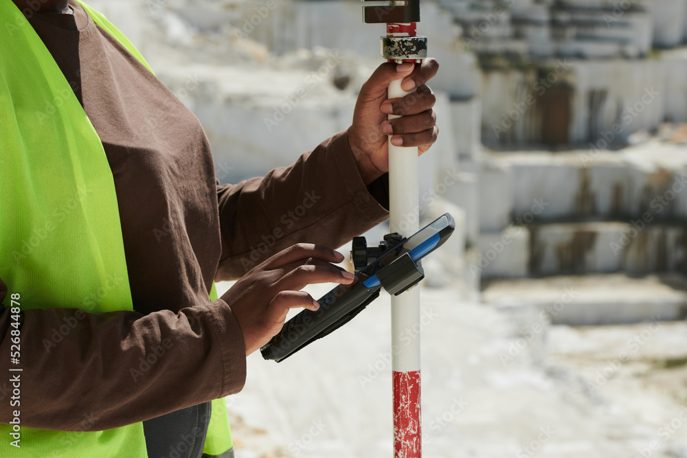 Poster hands of young black female worker of marble quarry scrolling through settings in smartphone while a