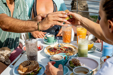 Obraz na płótnie Canvas Friends enjoying healthy breakfast, delicious pancakes with sweet strawberries, banana and chocolate 