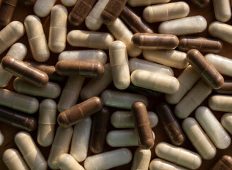 brown and white capsules. medicines, tablets
