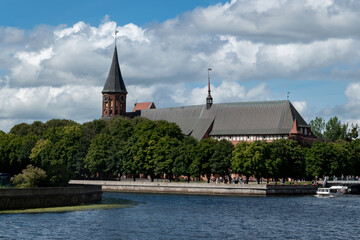 Embankment of river Pregol overlooking island of Kant in city of Kaliningrad, Russia. Kalingrad, keninsberg, summer tourism in russia. boat on water, baltika kant, anniversary of kant