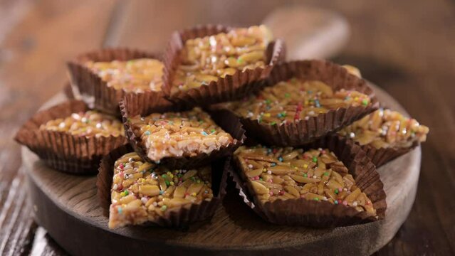 Desserts with almonds, peanuts and seeds in caramel. Traditional Sardinian sweet. Sweet squares. High quality 4k footage. Almond Gateau, sarda Food, for smartphones and social networks