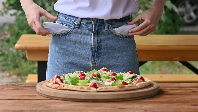 The woman has no money to pay for food. pulls empty pockets