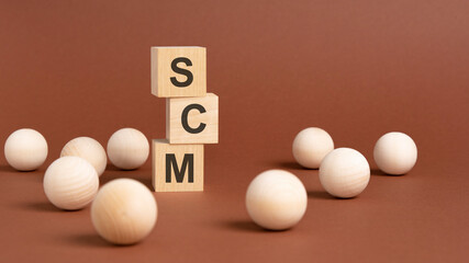 wooden cubes block with alphabet combine abbreviation SCM. SCM - short for Supply Chain Management