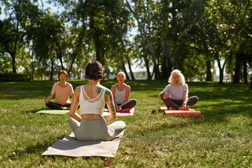 Female trainer teach mature people practice yoga