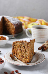 Homemade apple and carrot pie with cinnamon, raisins and peanuts, sprinkled with powdered sugar, Close-up