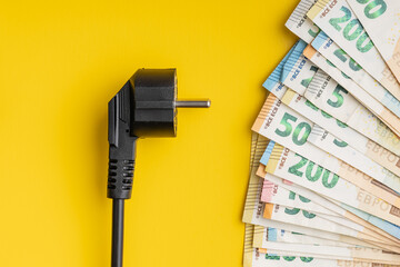 Electric plug and euro money. Concept of the increasing electricity prices. - obrazy, fototapety, plakaty