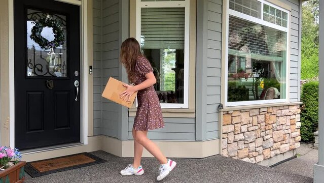 Birthday present delivered to your door teenage girl brings a gift in cardboard box under door to her friend She knocks on the door and runs away her hair grows She is in short dress and sneakers