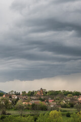 Small village in in Vojvodina, South Banat region, under rainy clouds