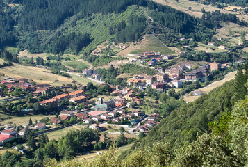 Fototapeta na wymiar Panoramic views of the town of Potes from Mount Arabades on a sunny day, Picos de Europa Natural Park, Cantabria, Spain